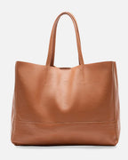 Brown leather tote bag on a white background