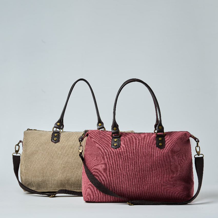 Two handbags, one beige and one red, on a light gray background
