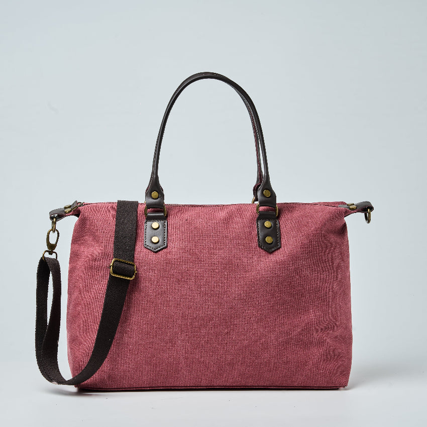 Burgundy tote bag with black straps on a light gray background