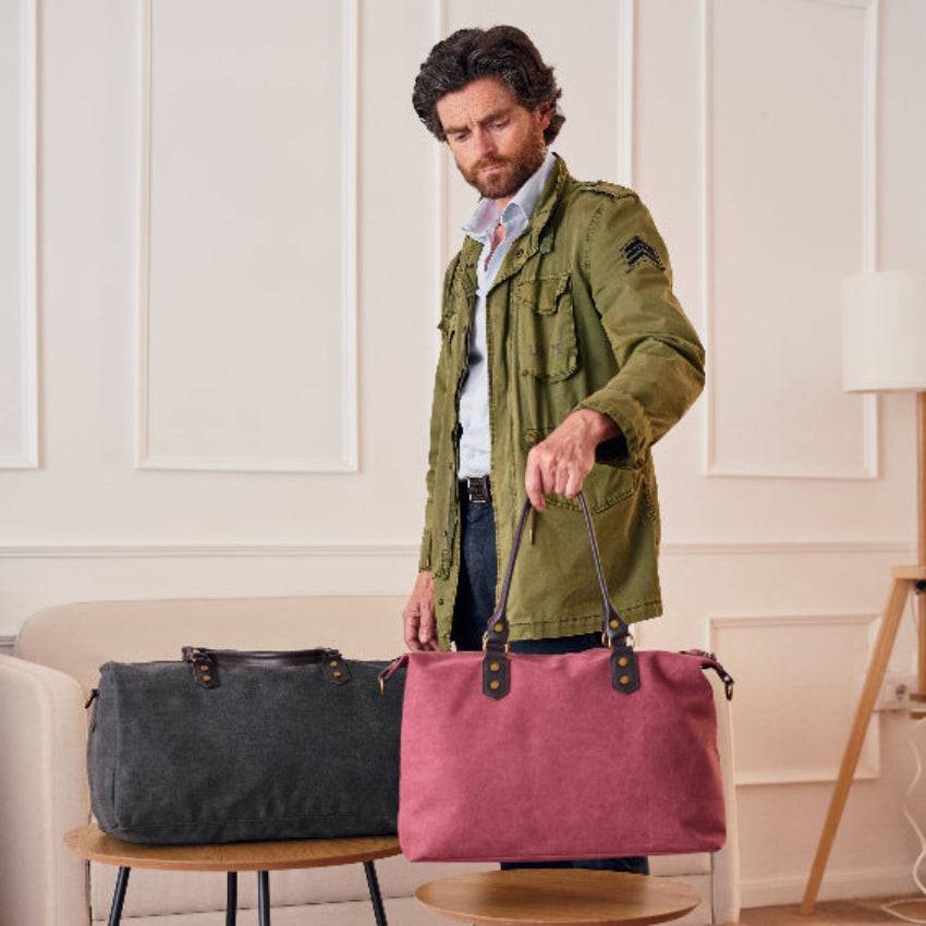 Two handbags, one gray and one red, on a light gray background