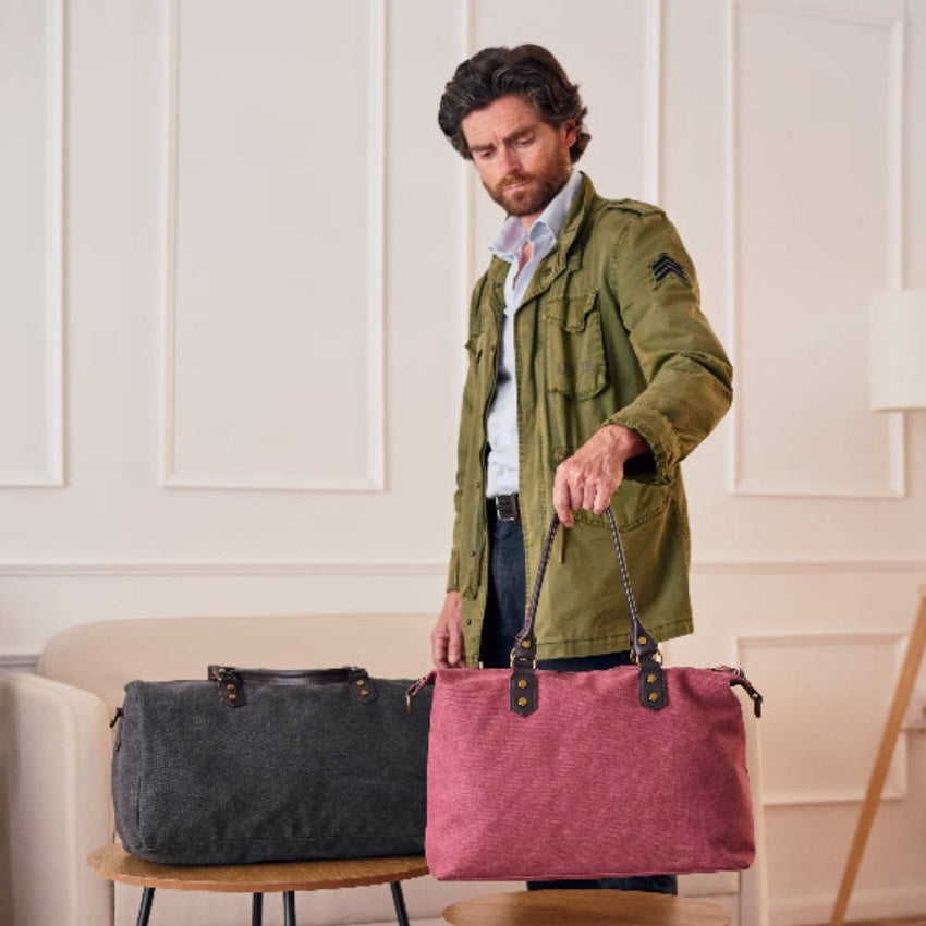 Two handbags, one gray and one red, on a light gray background